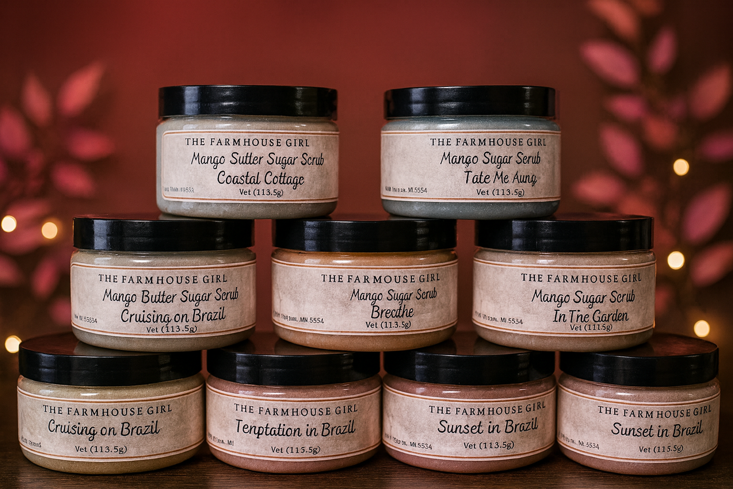 Collection of The Farmhouse Girl mango sugar scrubs with various scents on a wooden surface.
