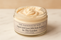 Jar of yogurt and goat milk body butter with visible label on a beige background