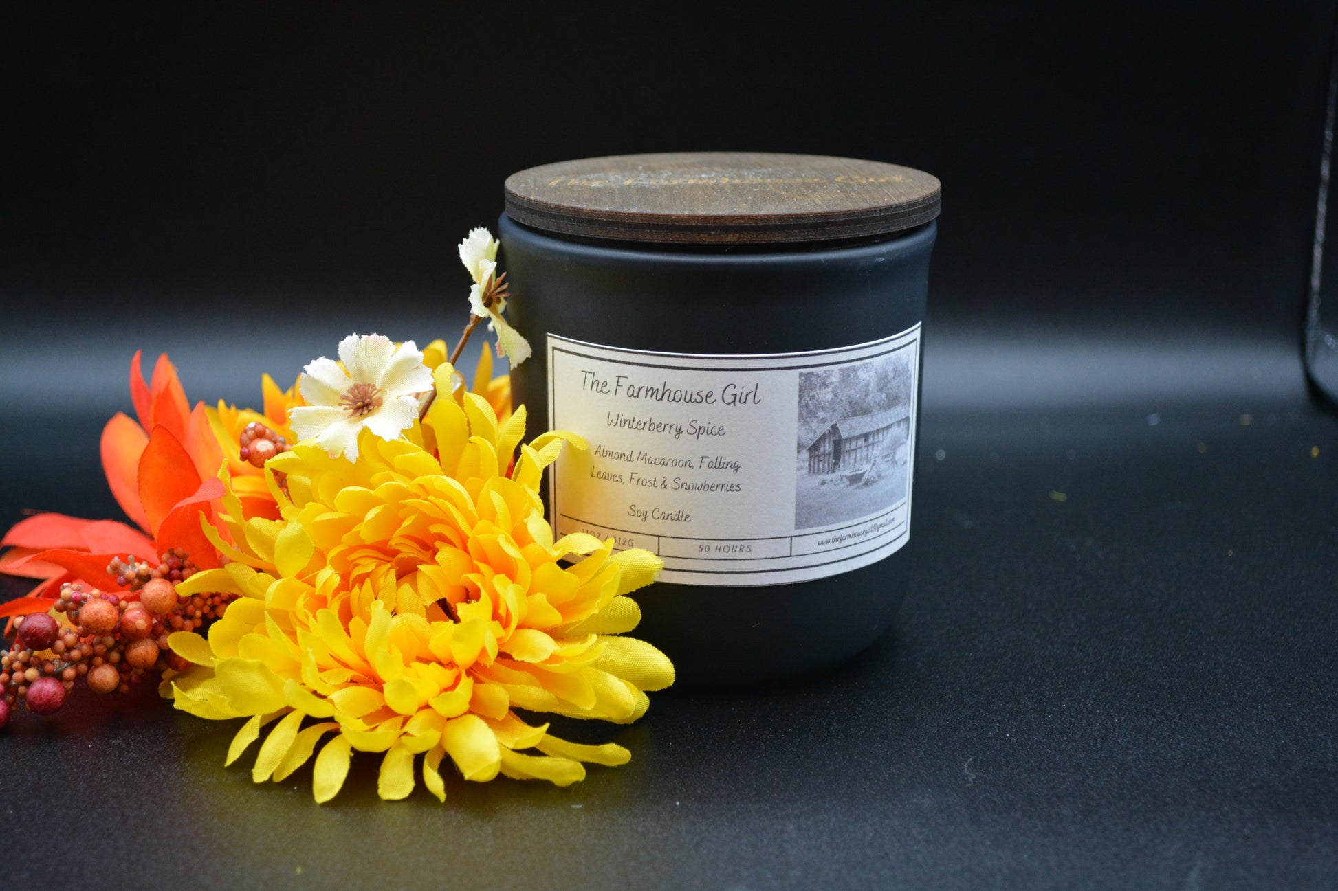 11 oz candle in a black ceramic jare with walnut lid names Winterberry Spice